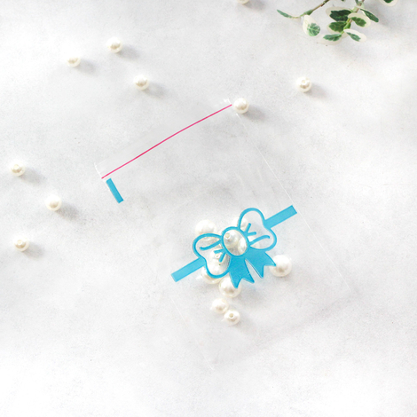 100 adet mavi fiyonk desenli bantlı şeffaf poşet / 10x15 cm - Bimotif