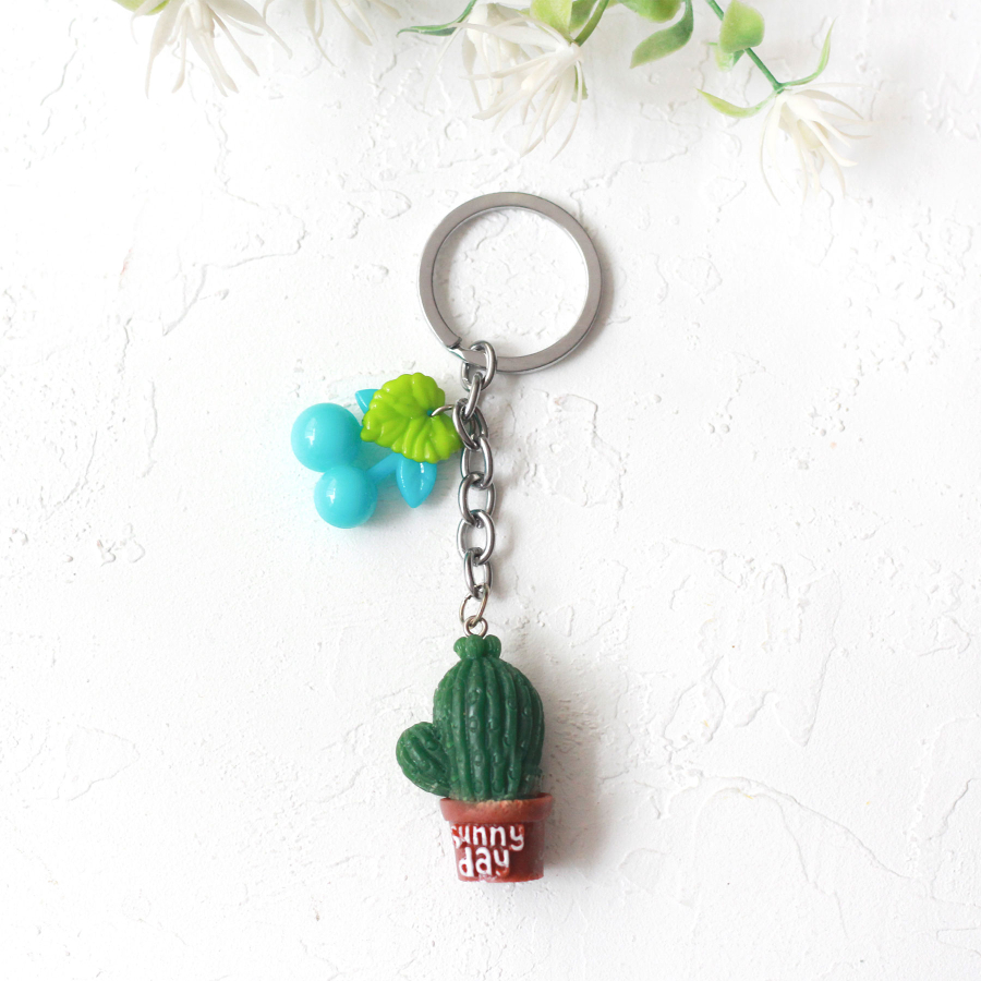 Cactus keyring with blue fruit and coffee pot, sunny day - 1